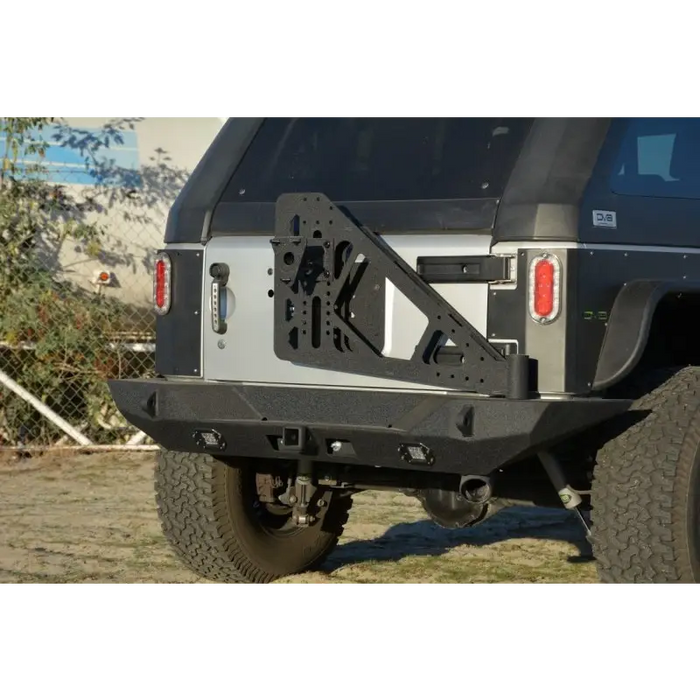 Black Jeep with mounted metal bumper tire carrier DV8 Offroad RS-10/RS-11 TC-6.