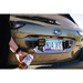 Person holding alcohol bottle near car by DV8 Offroad Universal License Plate Mount with Pod Light Mounts