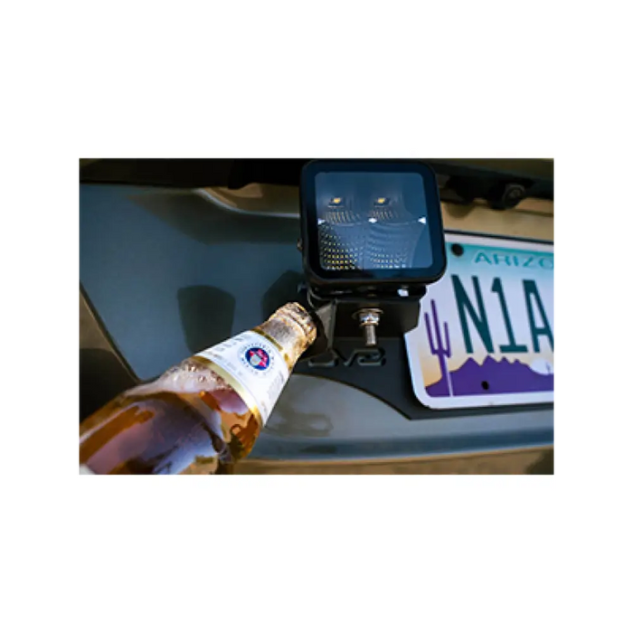 Universal license plate mount with pod light mounts and alcohol bottle in car