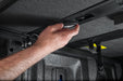 A man installing ceiling with a tool in extang solid fold alx for toyota tacoma