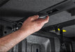 Man adjusting ceiling in extang solid fold alx for toyota tacoma - seo optimized alt text