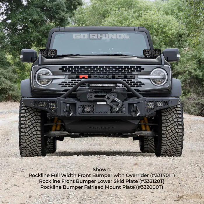 Off-road vehicle parked on dirt road with trees in background, fairlead mount plate.