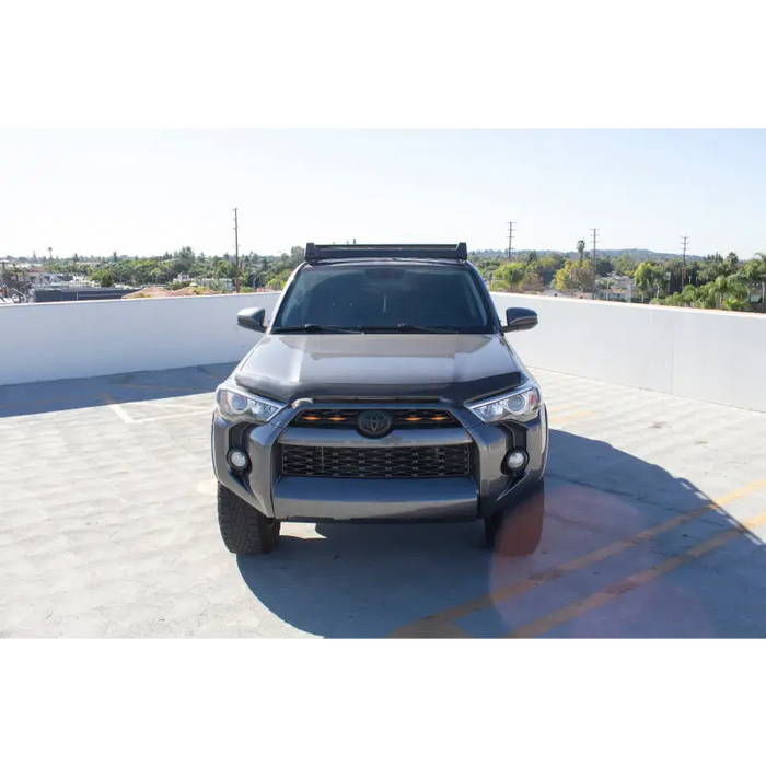 White Toyota 4Runner Ceros Low Profile Roof Rack parked in parking lot