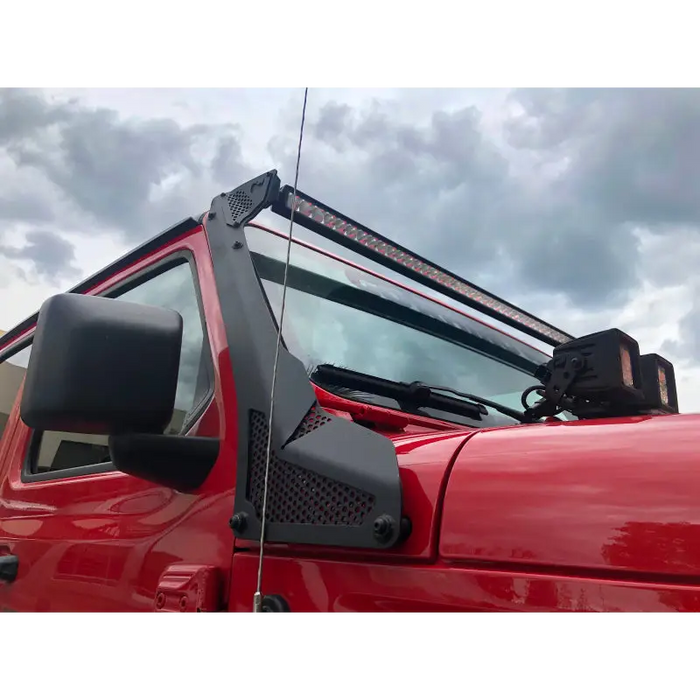 Red truck with black roof rack on Go Rhino Windshield Light Bar Mount for Jeep Wrangler.