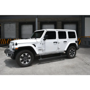 A white jeep with black wheels and a black bumper