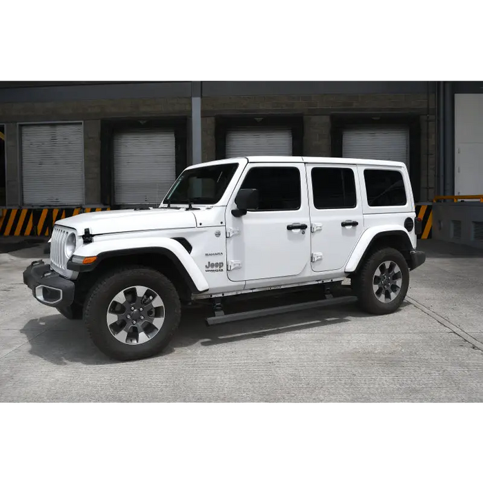 A white jeep with black wheels and a black bumper