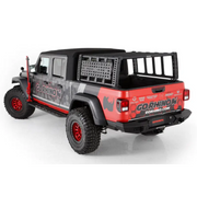 Red Jeep with black and white graphics parked in front of a house