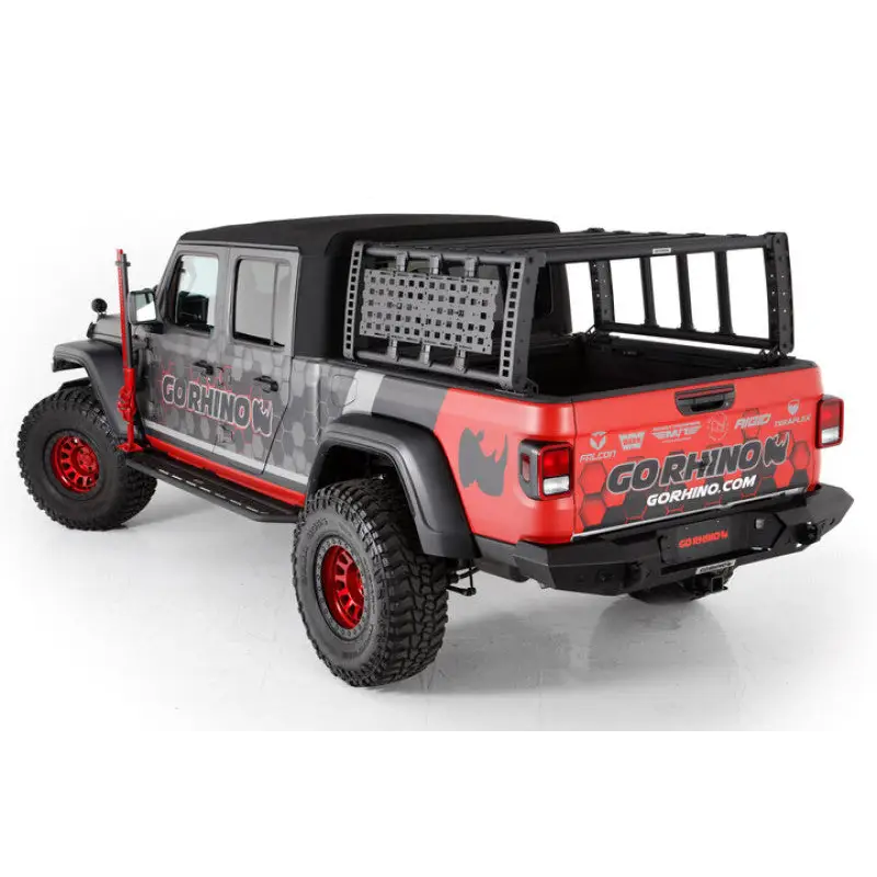 Red Jeep with black and white graphics parked in front of a house