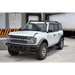 White truck parked in front of a building with electric running board