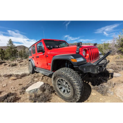Red jeep parked on rocky trail - go rhino dominator extreme d1 side steps - tex blk 80in