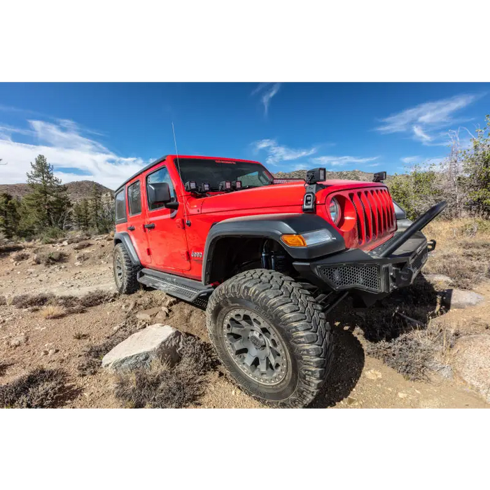 Red Jeep parked on rocky trail by Go Rhino Dominator Extreme D1 Side Steps - Tex Blk - 87in.