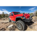 Red Jeep parked on rocky trail by Go Rhino Dominator Extreme D1 Side Steps - Tex Blk - 87in.