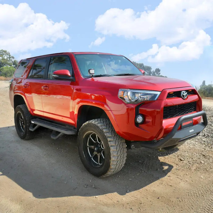 Red Toyota Tundra on a dirt road - Go Rhino RB10 Running Boards - Bedliner Coating Finish