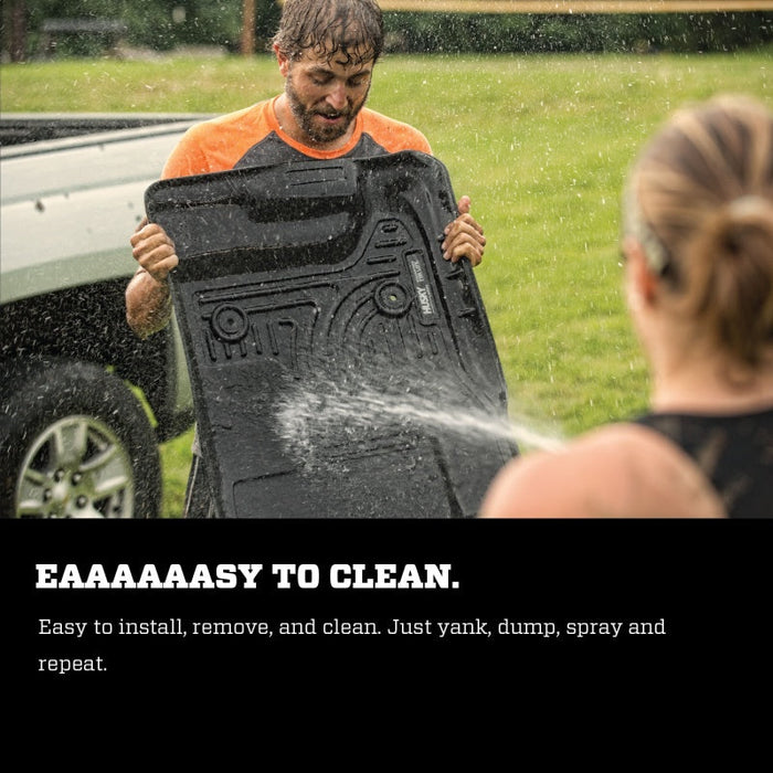 Man pouring water on floor liners during installation instructions