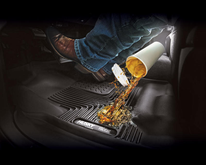 Husky liners pouring liquid on front floor mat for 2018 toyota tacoma