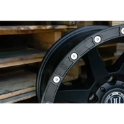 Black spoke wheel with spokes from ICON 17in Compression/Alpha/Rebound Rock Ring Kit