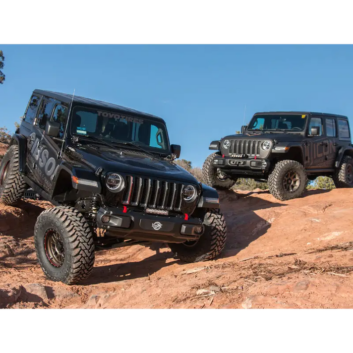 Two Jeeps parked on rocky hill under blue sky - ICON 2018+ Jeep Wrangler JL 2.5in Stage 1 Suspension System