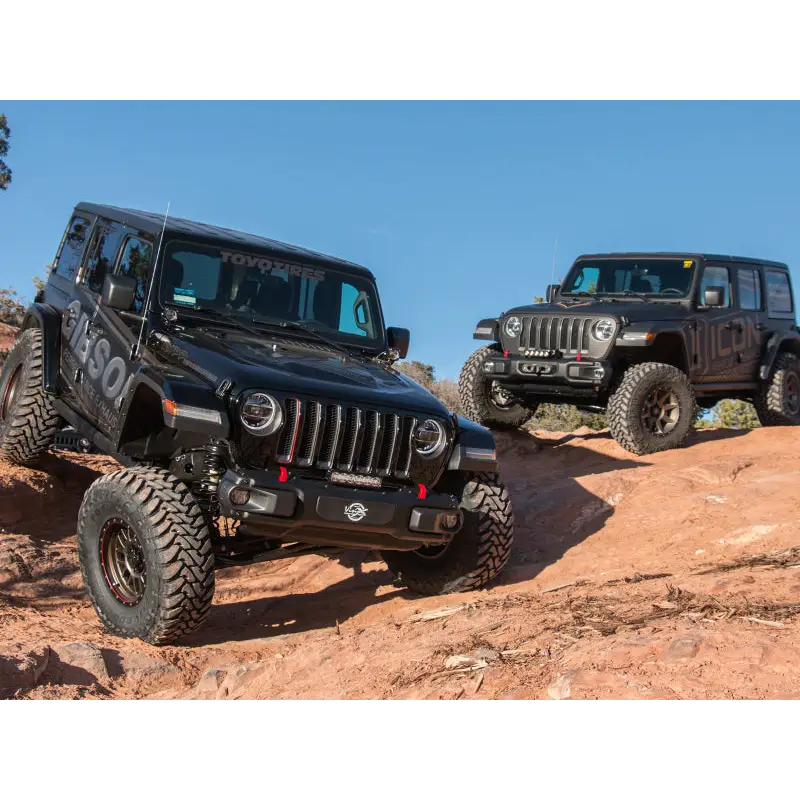 Jeep Wrangler JL 2.5in Stage 2 Suspension System with two jeeps parked on rocky hill