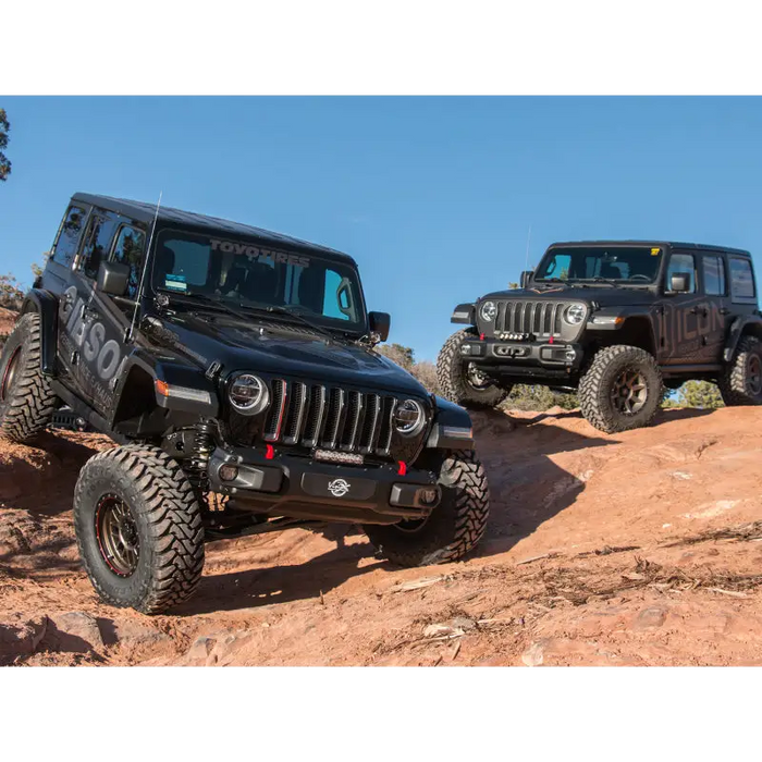 Jeep Wrangler JL 2.5in Stage 2 Suspension System with two jeeps parked on rocky hill