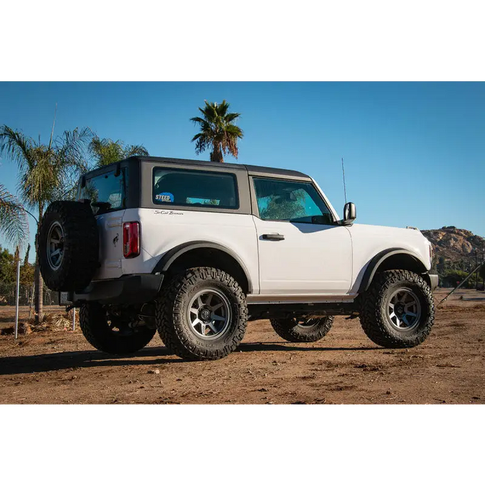 White Ford Bronco with black tire cover - ICON 2021+ 3in Lift C/O Spacer Kit.