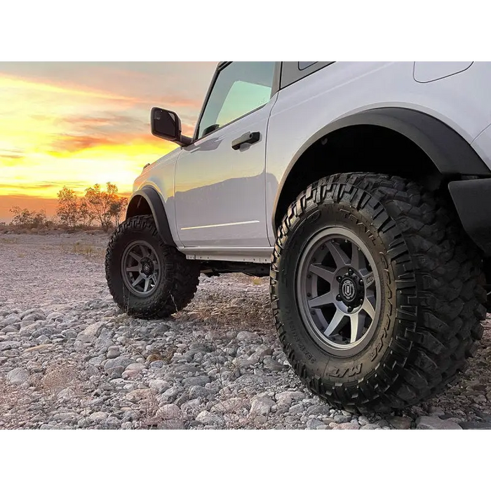 White truck with big tire featuring ICON 2021+ Ford Bronco 3in Lift C/O Spacer Kit.