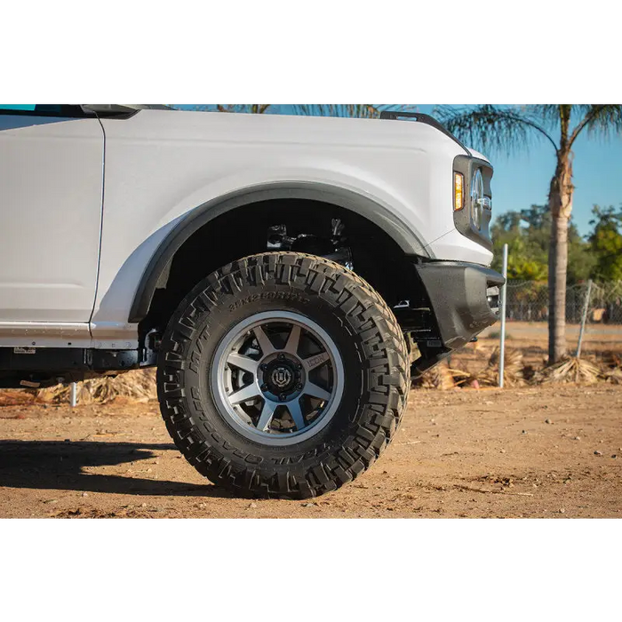 White truck with black tire - ICON 2021+ Ford Bronco lift coilover spacer kit.