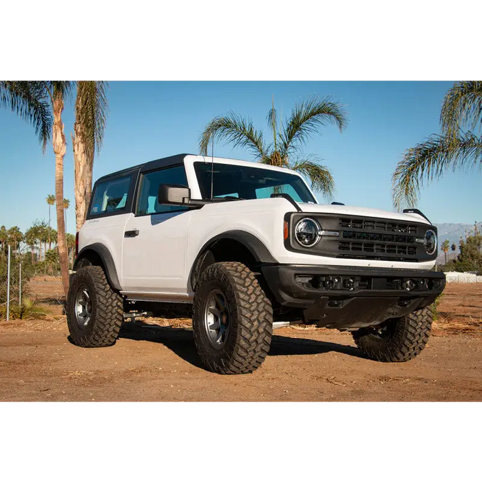 White Ford Bronco with a large tire, ICON 3in Lift Coilover Spacer Kit