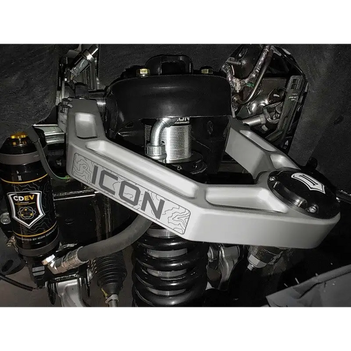 ICON 2021+ Ford Bronco Billet Upper Control Arm Delta Joint Kit with beer bottle near motorcycle bottom