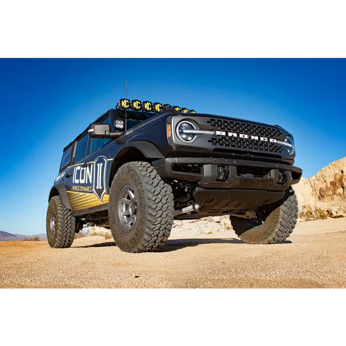 Off-road Ford Bronco with coilover suspension parked in desert.