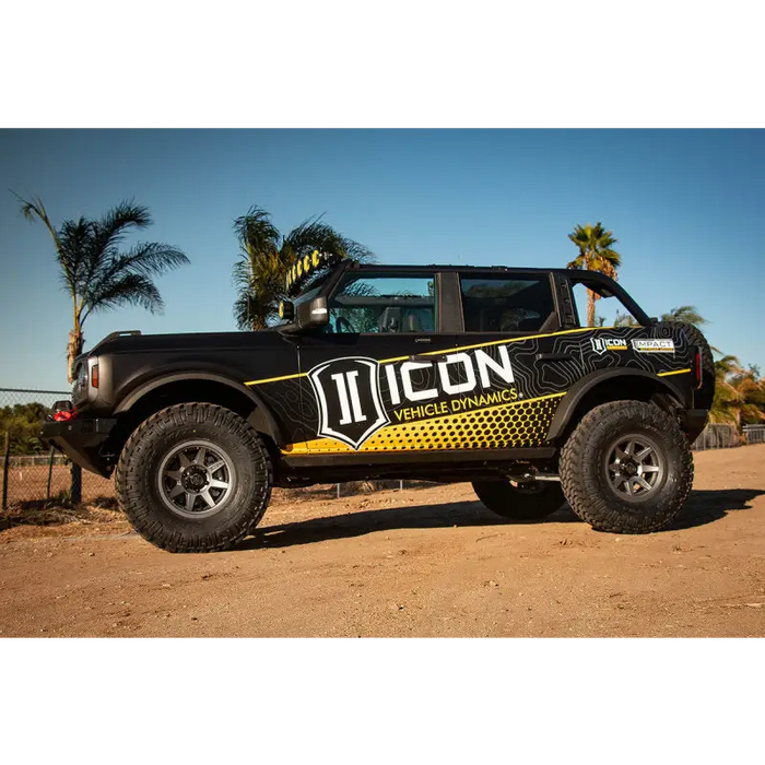 Yellow and black decal truck with ICON 21+ Ford Bronco Tubular Rear Track Bar Kit.