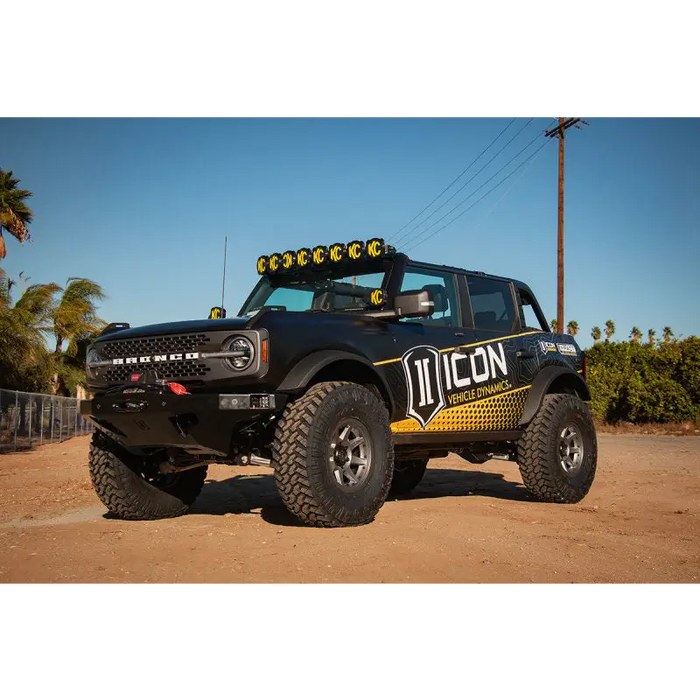 Black truck with yellow and black decal on it, ICON 21+ Ford Bronco Tubular Upper Control Arm Delta Joint Kit.