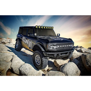 Black Ford Bronco rear lift kit with yellow light on truck ramp