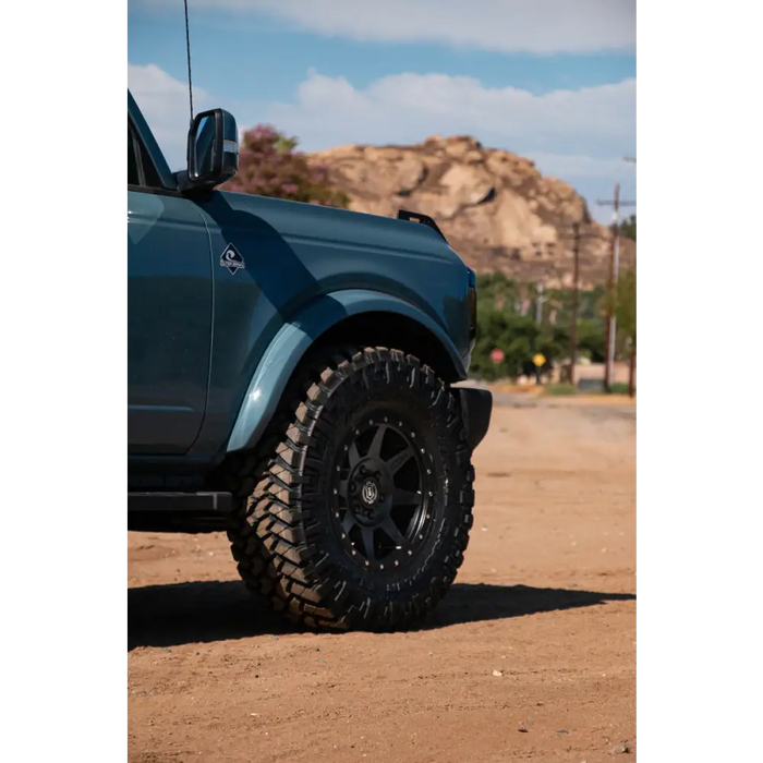 Blue truck with big tire featuring ICON Rebound 17x8 wheel.