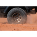 Black Jeep driving through desert with ICON Rebound Pro 17x8 wheel.