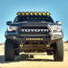 Black Toyota Tacoma truck with yellow bumper light - KC HiLiTES Pro6 Gravity LED Combo Beam Overhead Light Bar Sys