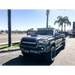 Toyota Tacoma truck with lift bed displaying KC HiLiTES Pro6 Gravity LED overhead light bar.