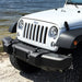 White Jeep parked by lake near Gravity LED Pro Headlights.