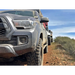 Toyota Tacoma driving down dirt road with LED fog beam.