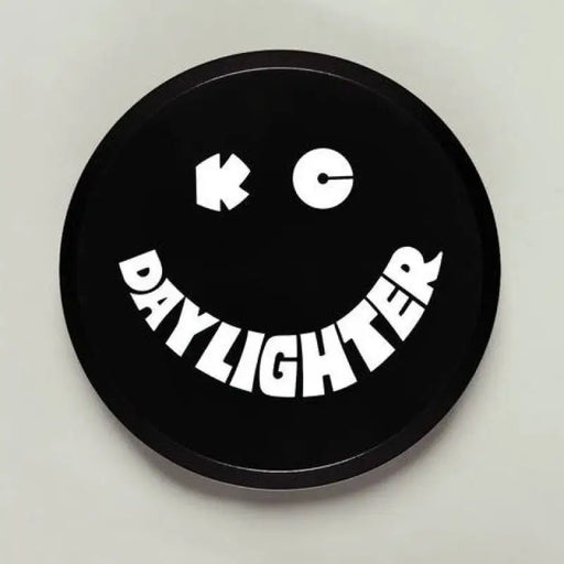 Black and white plastic light cover with ’happy’ button for KC HiLiTES.