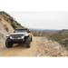 Jeep driving down dirt road with round soft vinyl light covers