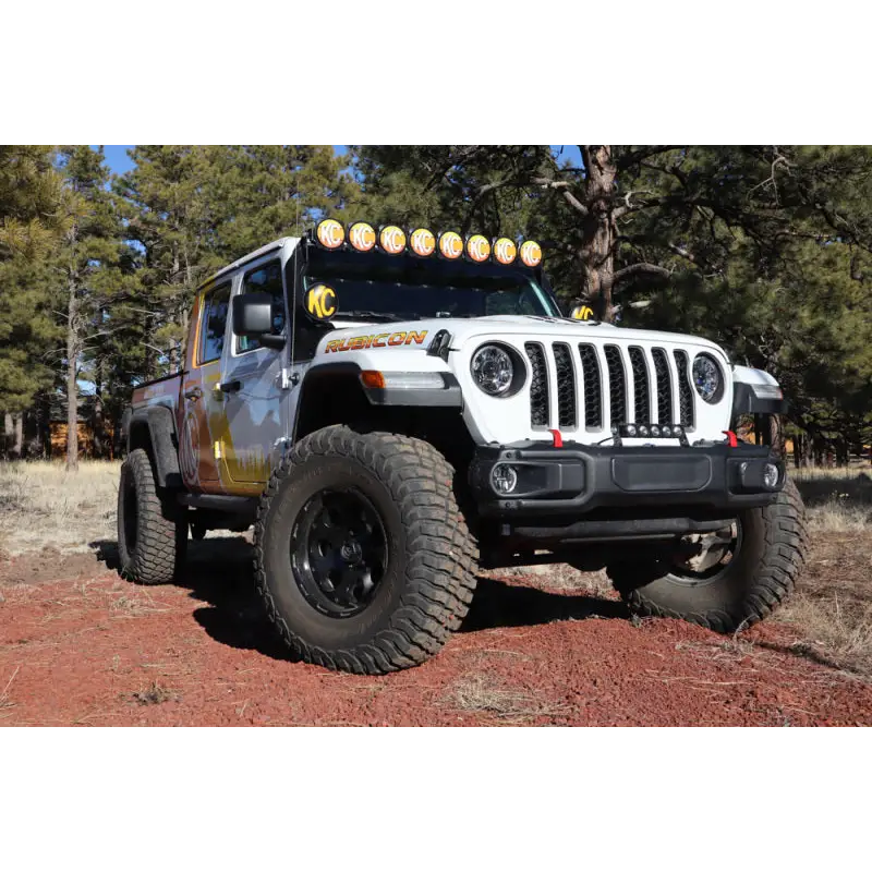 Jeep with light bar covered by KC HiLiTES 6in. Round Soft Covers in Black w/Yellow Logo