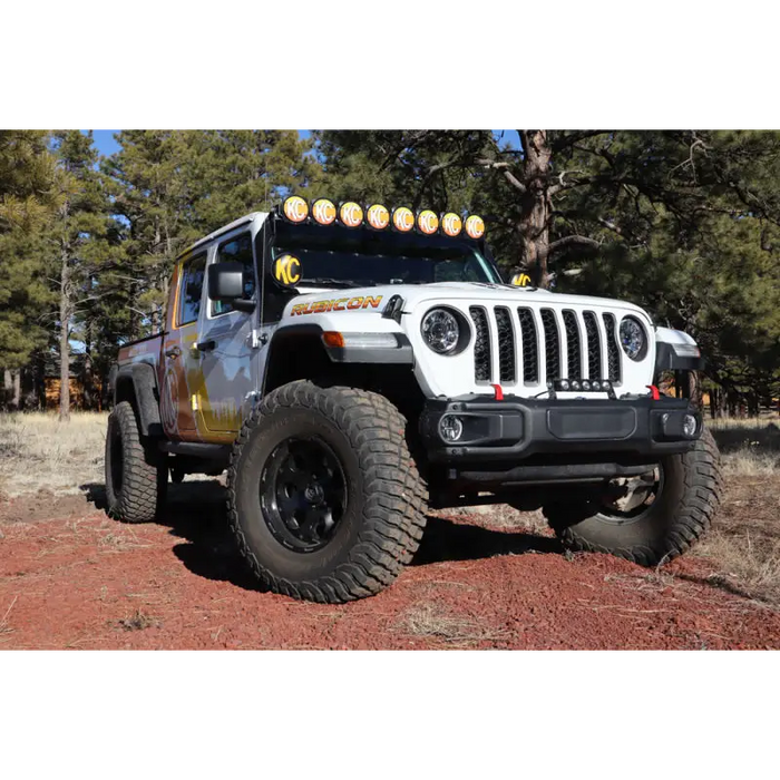 Jeep with light bar covered by KC HiLiTES 6in. Round Soft Covers in Black w/Yellow Logo