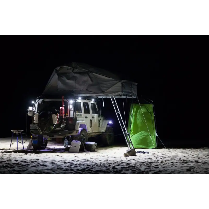 Man sitting in van at night under KC HiLiTES C-Series C2 LED 2in. Area flood light - pair pack, black.