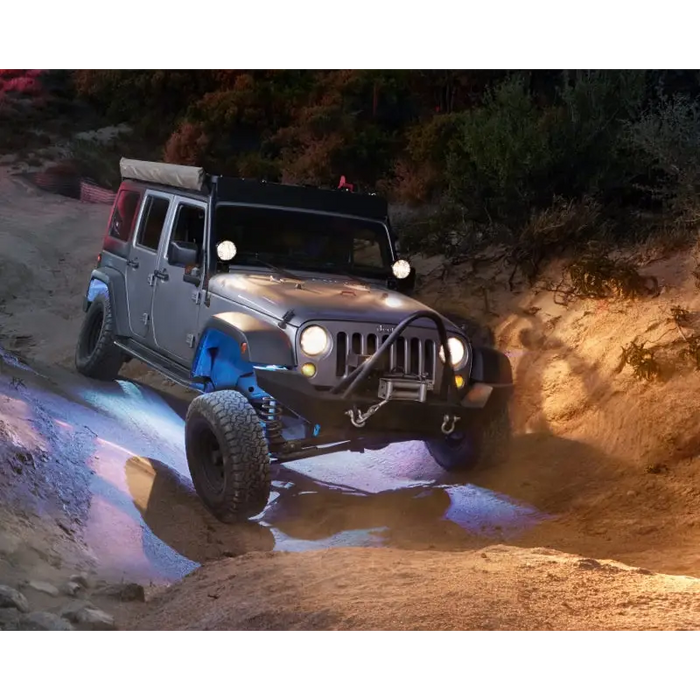 Jeep driving through muddy trail with KC HiLiTES C-Series RGB LED rock lights - set of 6.