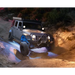 Jeep driving through muddy trail with KC HiLiTES C-Series RGB LED rock lights - set of 6.