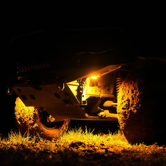 KC HiLiTES Cyclone V2 LED Rock Light shines on car with flashlight, 6-Light System in Amber - 5W Flood Beam