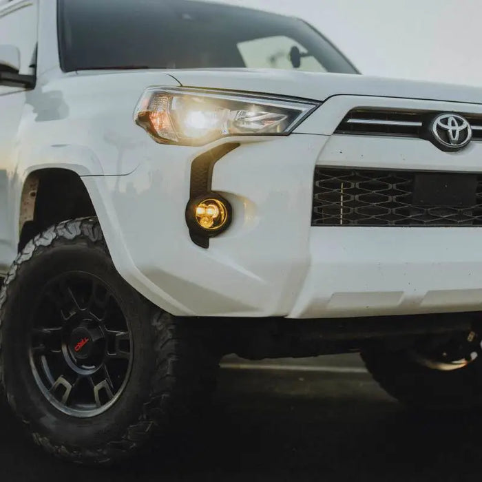 White Toyota SUV parked on beach - KC HiLiTES FLEX ERA 3 Dual Mode SAE Fog Lights