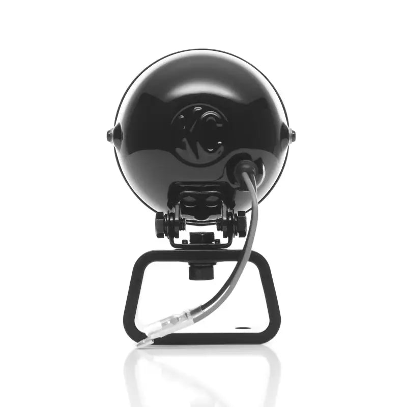 Black helmet mounted on stand for KC HiLiTES Rally 400s spread beam pair pack.