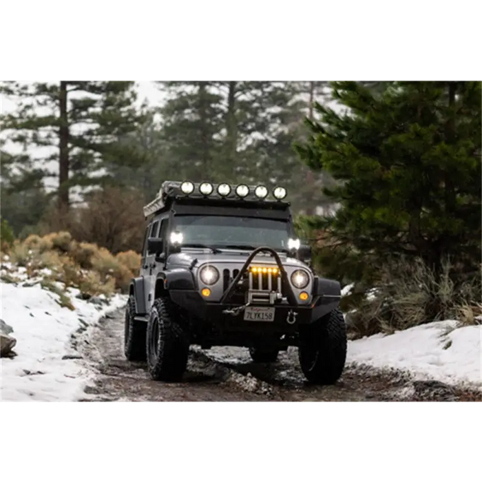 Jeep driving on snowy road with KC HiLiTES SlimLite 6in. LED lights