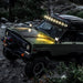 Green Jeep driving through rocky terrain with SlimLite® LED lights on - KC HiLiTES SlimLite 6in. LED Light 50w Spot Beam (Pair